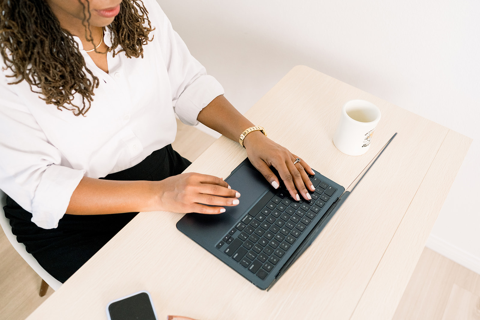 Temecula realtor poses as she types on laptop for brand session