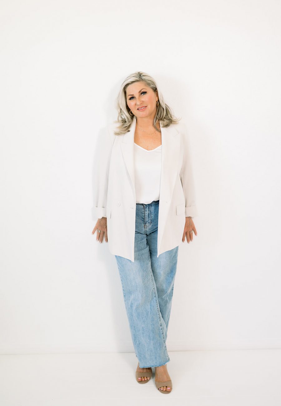 esthetician in casual professional attire posing for a personal branding session for her aesthetics website